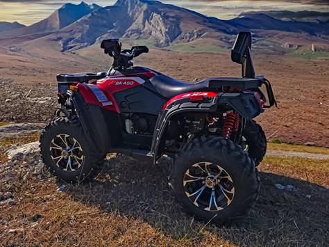 A red and black four wheeler on a hill

Description automatically generated